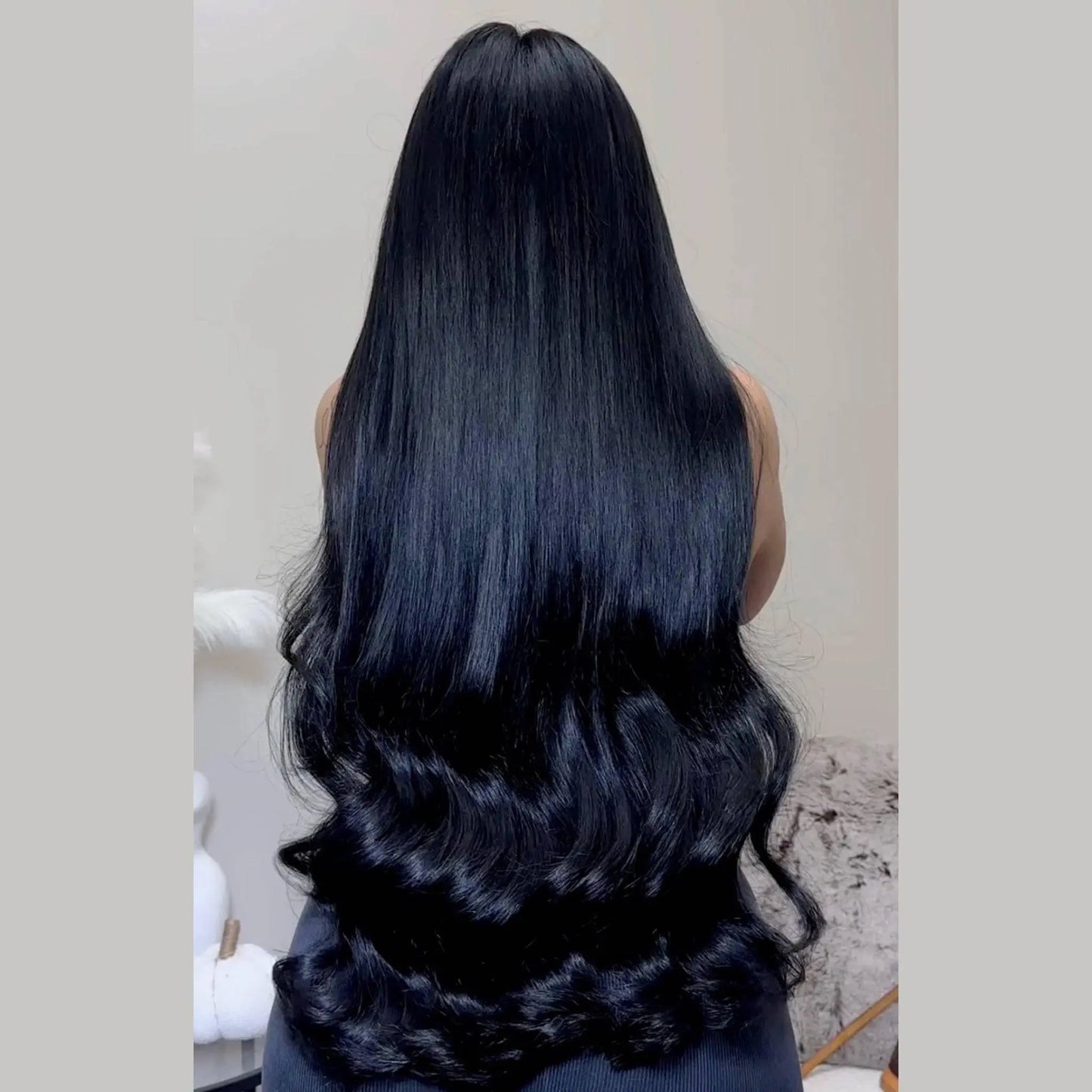 Woman with long jet black hair extensions - raw hair bundles