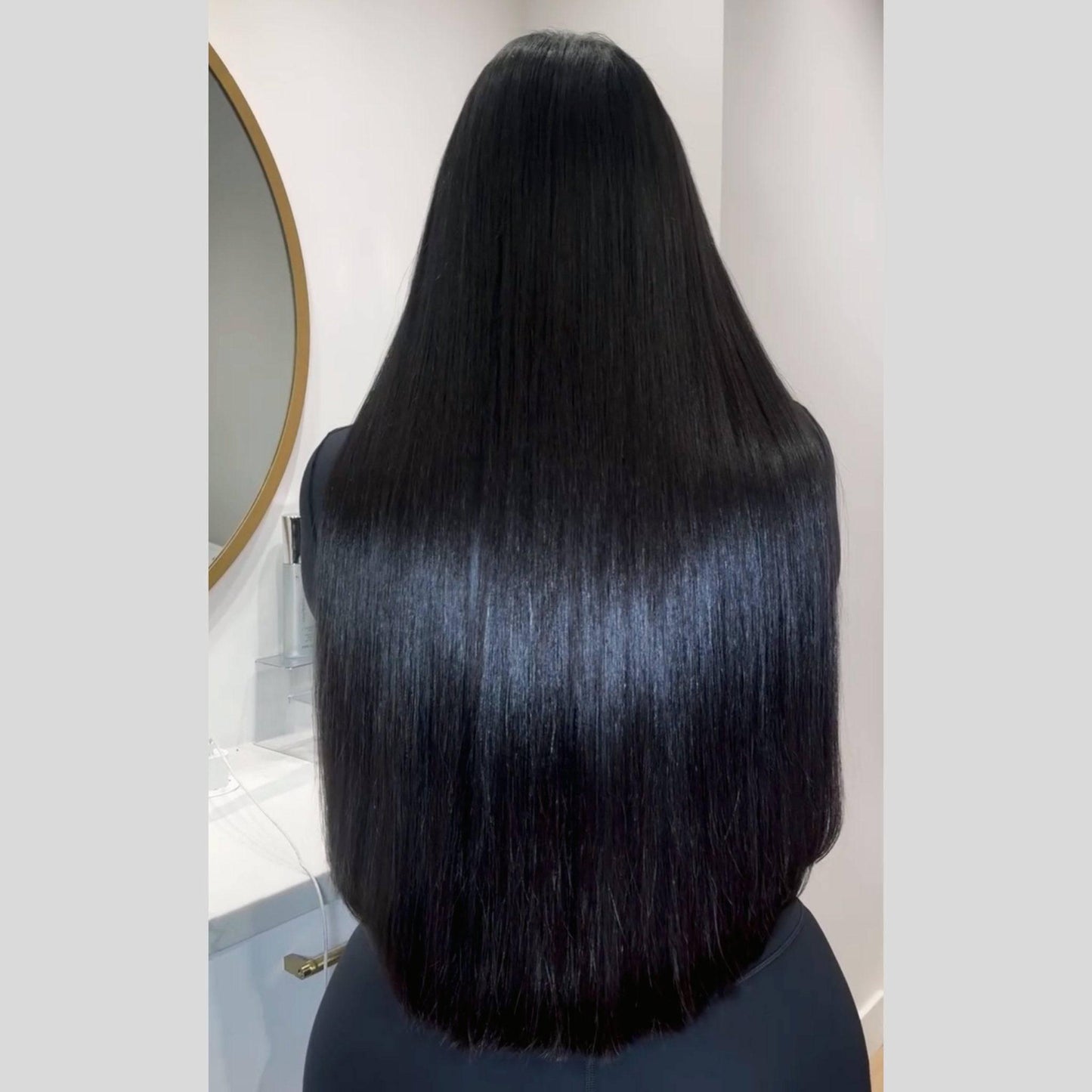 Woman with long jet black hair extensions - raw hair bundles
