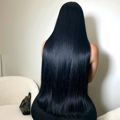 Woman with long jet black hair extensions - raw hair bundles