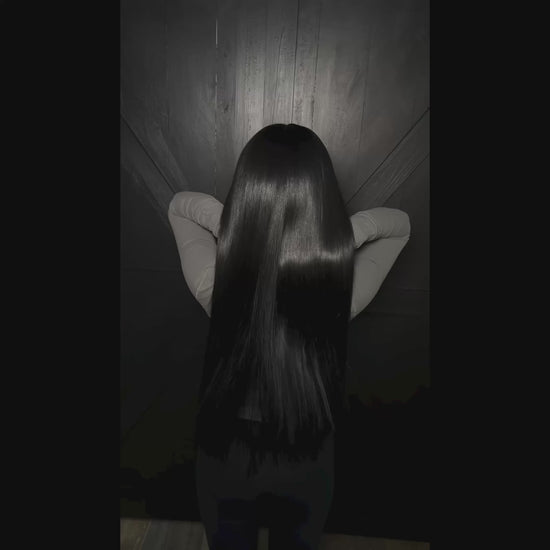 Woman with long jet black hair extensions - raw hair bundles