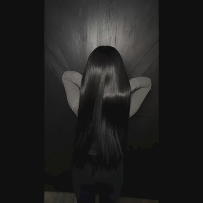 Woman with long jet black hair extensions - raw hair bundles